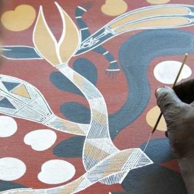 Aboriginal artist at work on a traditional painting at the Injalak Art and Craft Centre (Gunbalanya)